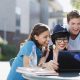 Students using laptop together outdoors